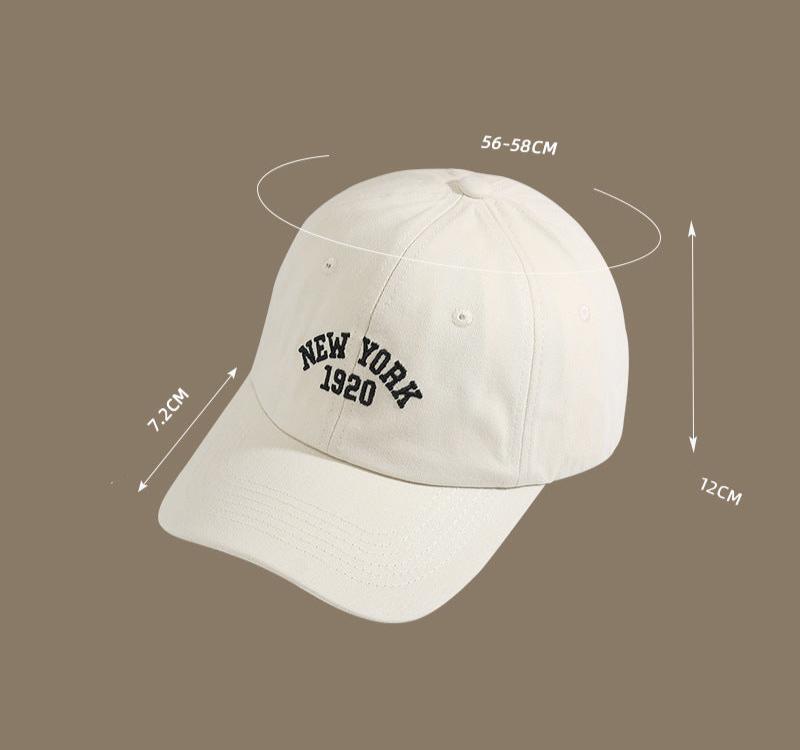 Angled view of a beige "New York 1920" cap with labeled size dimensions