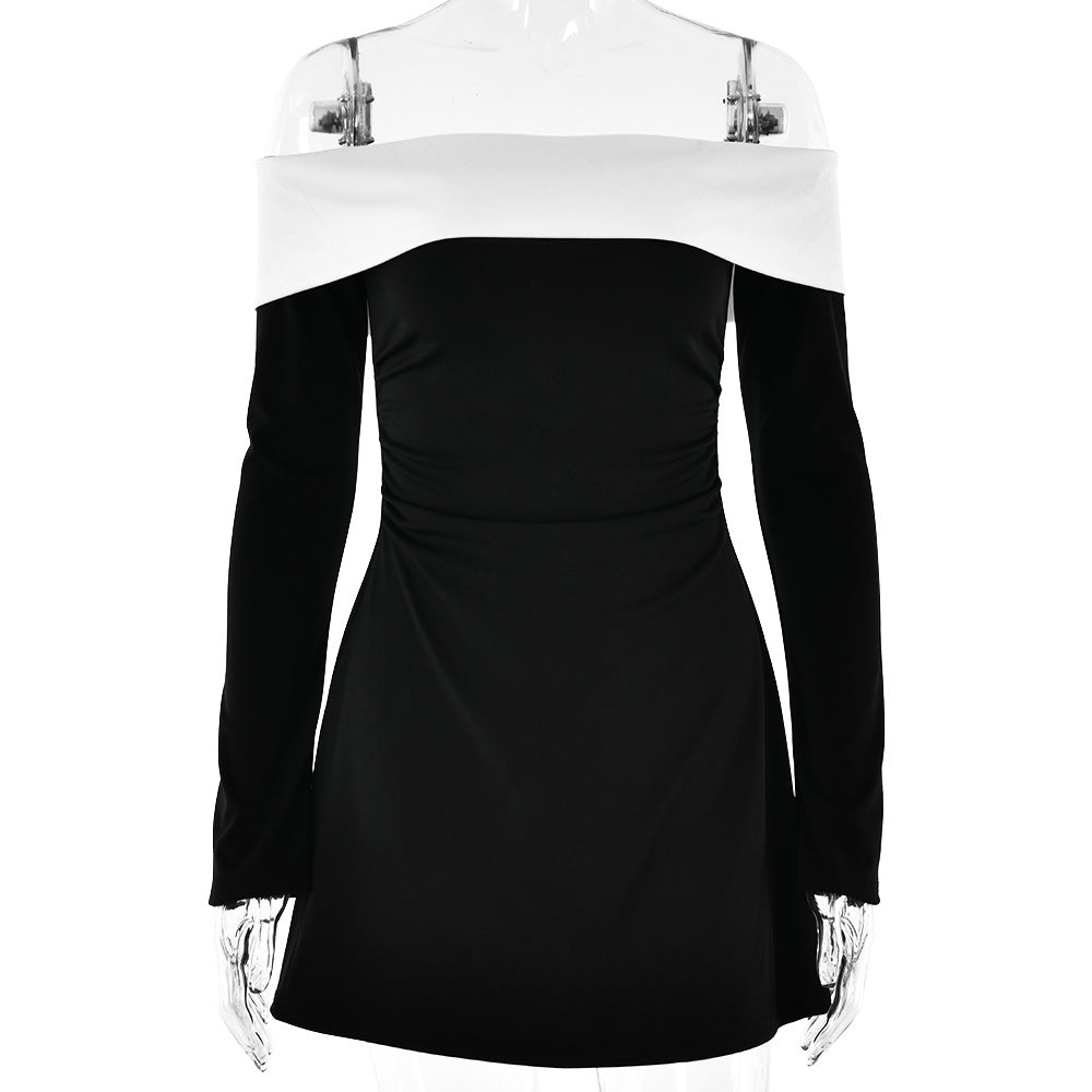 Product photo of a black mini dress with white off-shoulder detail and long sleeves on a mannequin