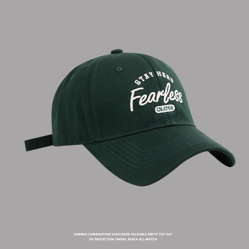Dark green baseball cap with white Stay Hard Fearless logo