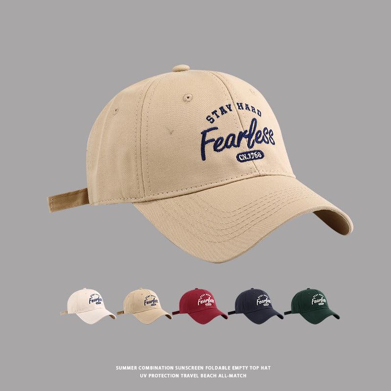 Beige baseball cap with Stay Hard Fearless embroidery and color options display below