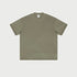 Olive green oversized t-shirt displayed flat against light gray background with branded tag visible