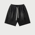 Black drawstring shorts with elastic waistband displayed flat against light gray background
