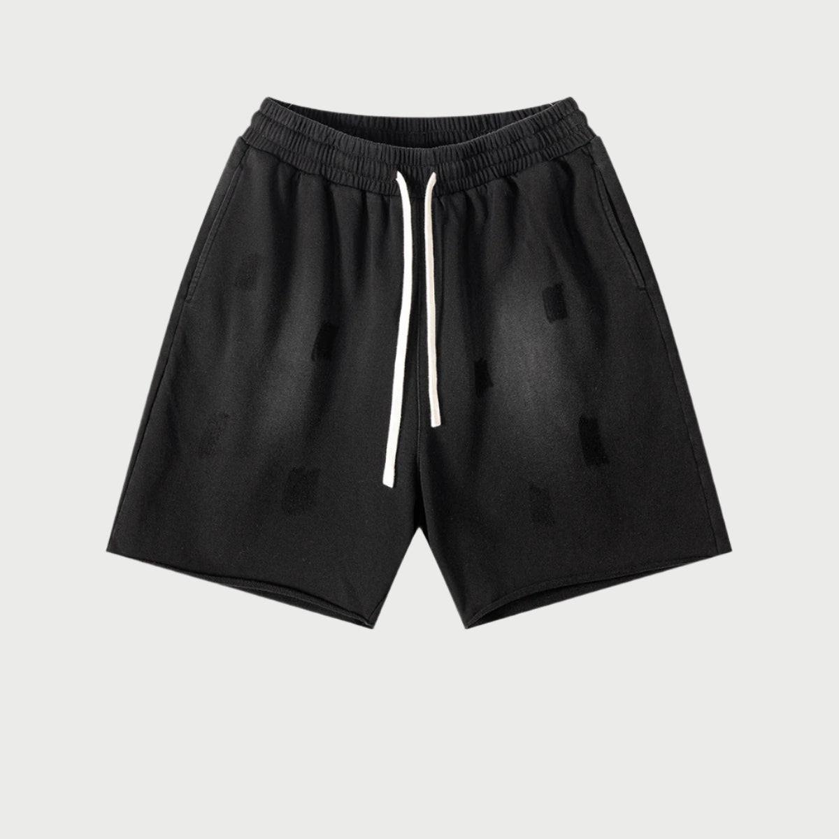 Black drawstring shorts with elastic waistband displayed flat against light gray background