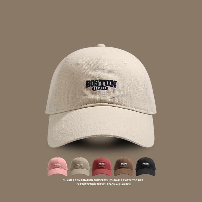 Beige baseball cap with white Boston 1630 embroidery, shown with color variants below