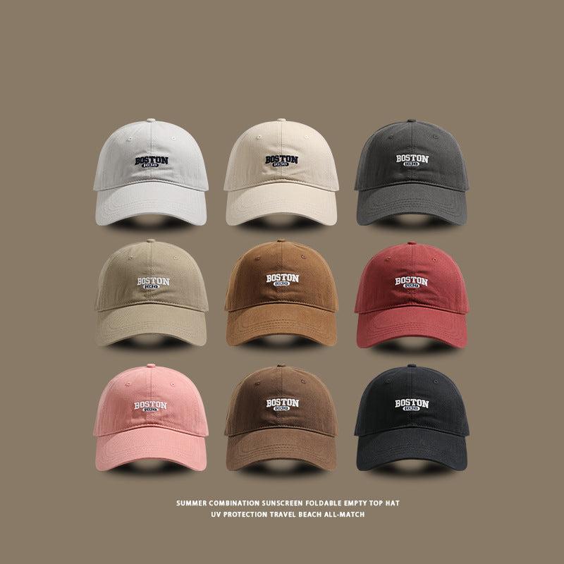 Grid display of baseball caps in white, beige, charcoal, khaki, brown and burgundy with Boston 1630 logo