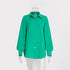 A bright green textured cotton button-down shirt with collar and balloon sleeves displayed on transparent mannequin against white background