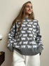 Gray knit sweater with white sheep pattern worn with cream pants