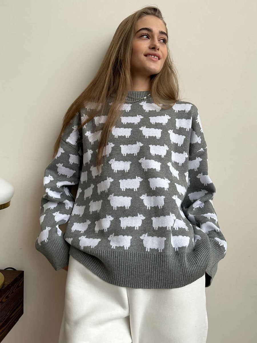 Gray knit sweater with white sheep pattern worn with cream pants