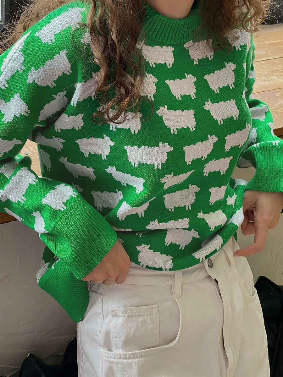 Kelly green sweater with white sheep pattern paired with white pants