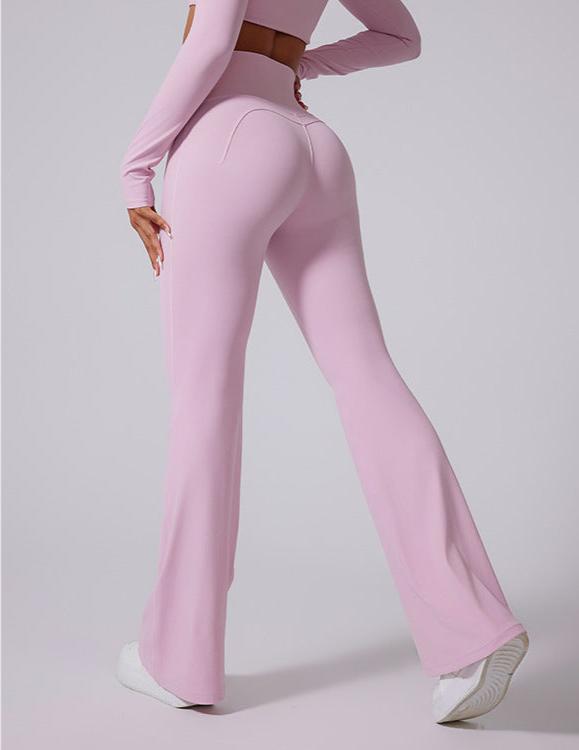 Side view of lilac flared yoga pants with V-shaped waistband and brown belt detail, styled with white sneakers on gray backdrop