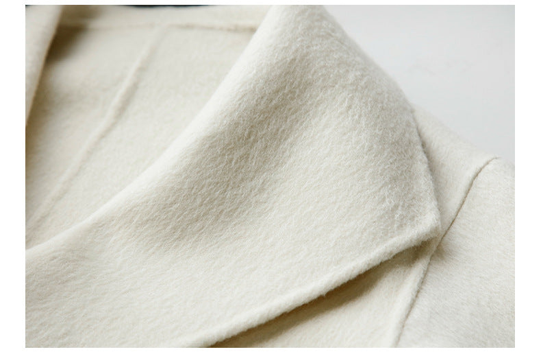 Extreme close-up of cream wool fabric texture showing plush brushed finish