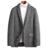 Front view of gray glen plaid blazer styled with white turtleneck. Single button design with notched lapels and structured shoulders for business-casual wear
