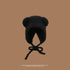 A black teddy bear bonnet with ear details and chin ties displayed against brown background, showcasing plush material construction