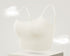 Soft white seamless bra with adjustable thin straps, providing a smooth and comfortable fit.