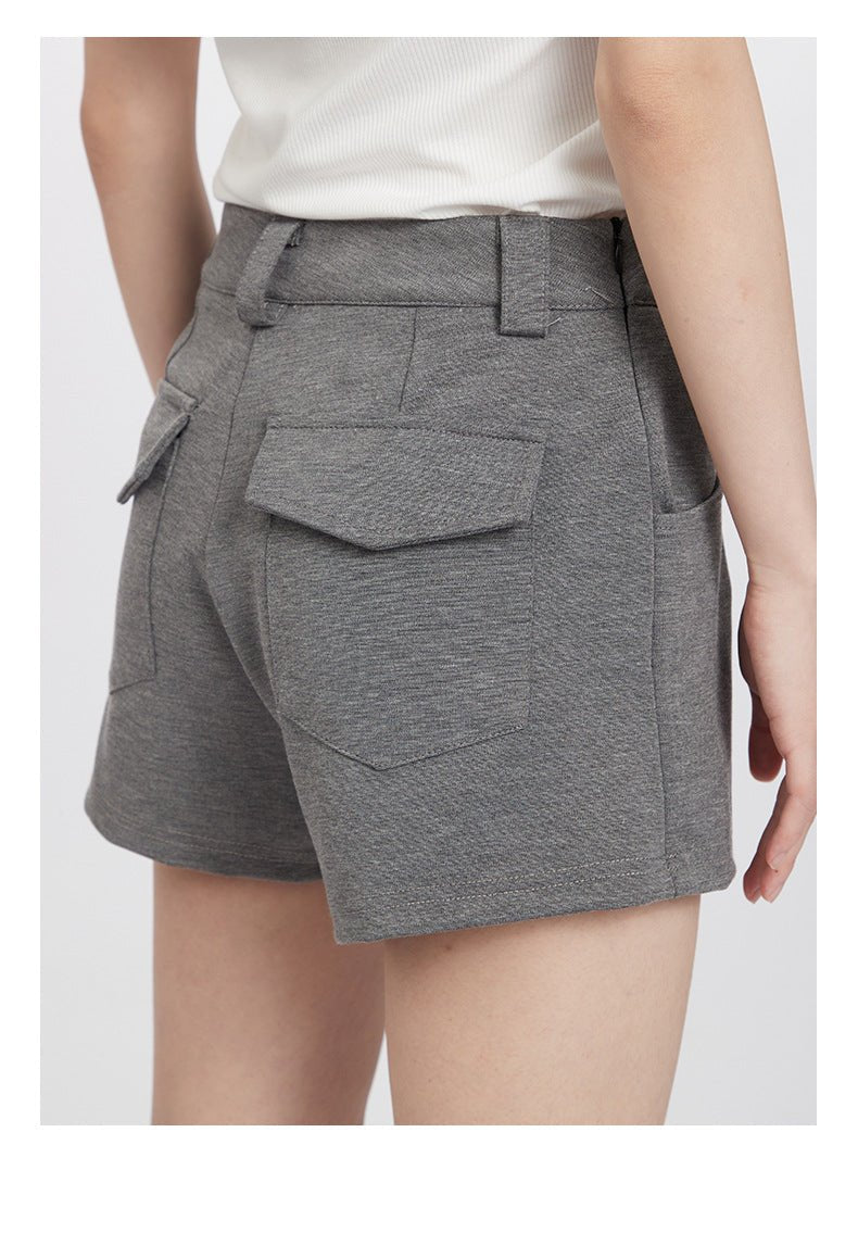 Close-up of back pocket details on gray tailored shorts with premium stitching
