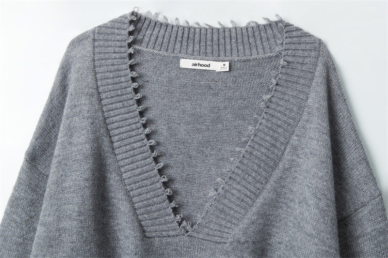 Deep V-neck detail with ribbed trim and Airhood brand label, showing intricate stitch pattern at collar.