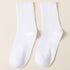 A pair of white ribbed crew socks displayed flat against cream background showing texture and full length
