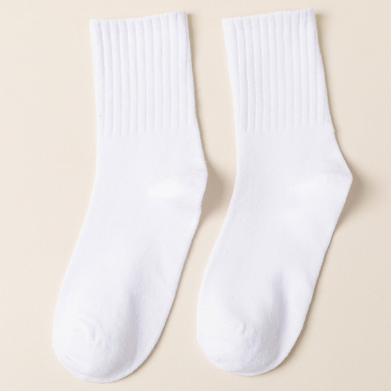 A pair of white ribbed crew socks displayed flat against cream background showing texture and full length