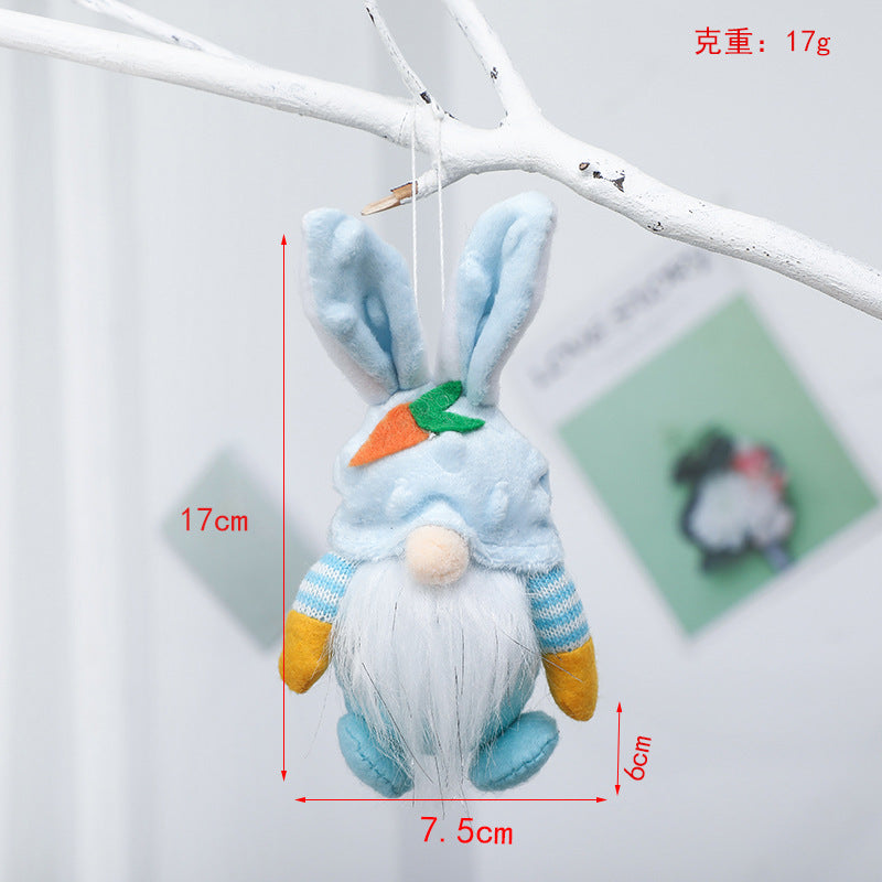 Blue plush bunny gnome ornament with carrot detail, hanging. Dimensions: 17cm height, 7.5cm width, 6cm depth, weight 17g.