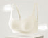Seamless cream colored bra with a wireless design and gentle support, displayed in a floating showcase.