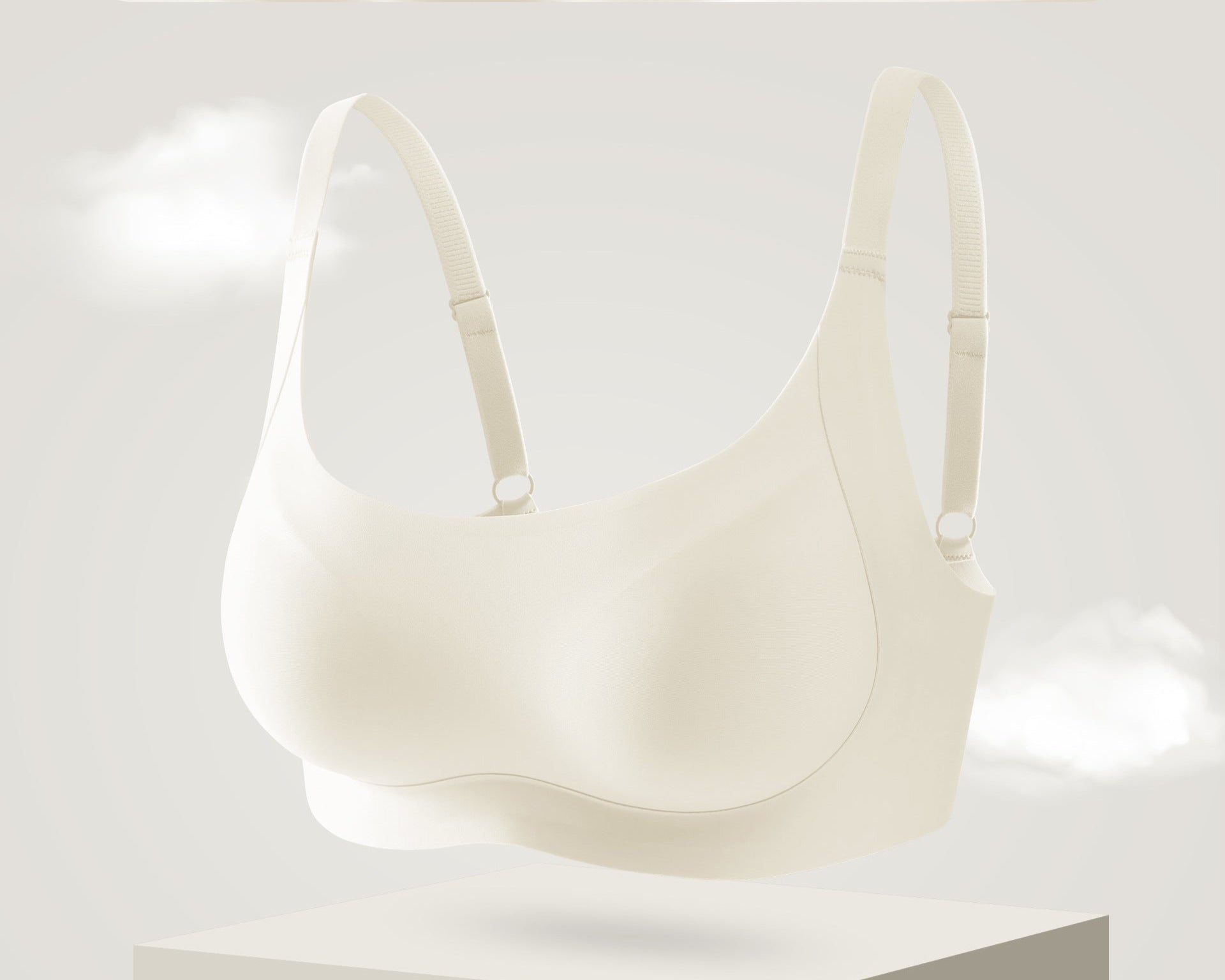 Seamless cream colored bra with a wireless design and gentle support, displayed in a floating showcase.