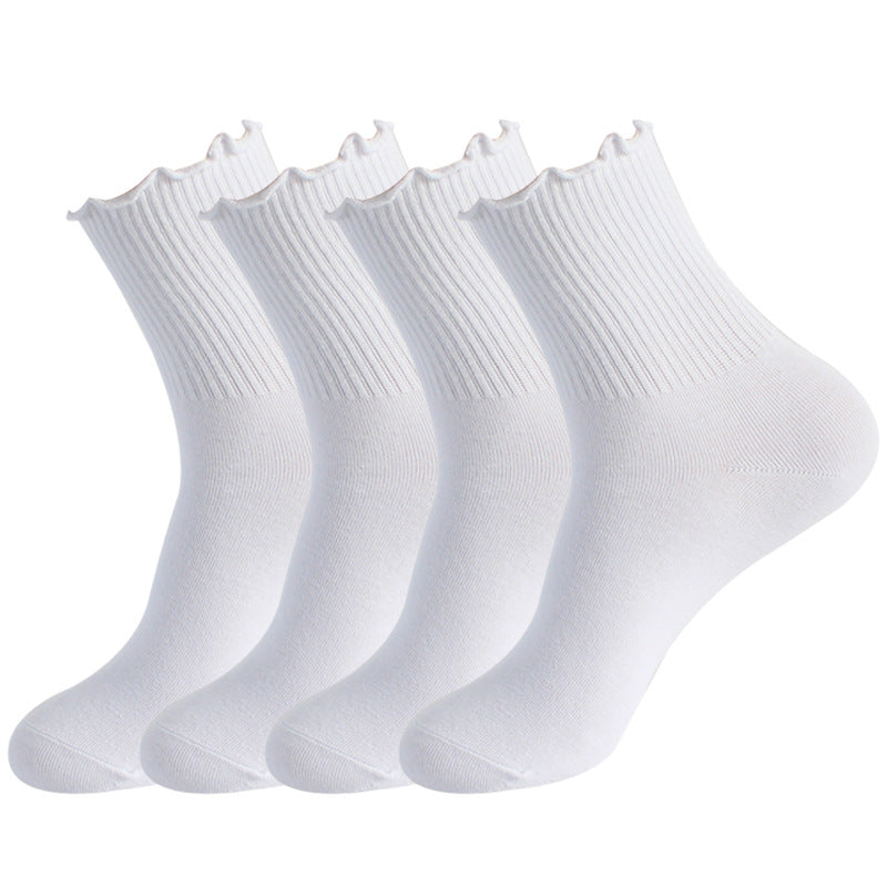 Four pairs of white ankle socks with ribbed cuffs and scalloped edges arranged side by side against white background