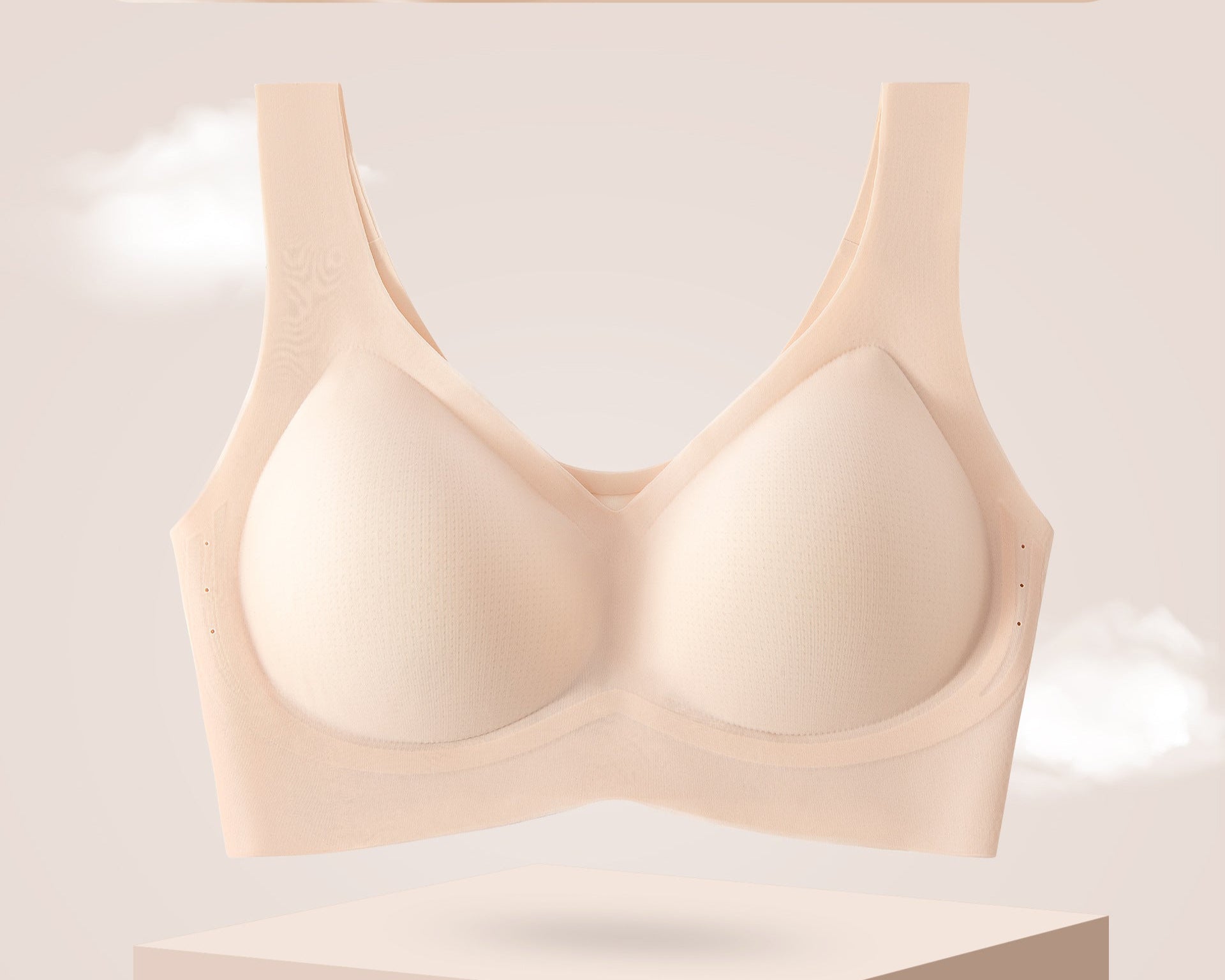 Beige seamless bra with breathable design on a pedestal.