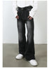 Model with hands in pockets wearing white button-up shirt, black belt and black wide-leg denim jeans with white sneakers