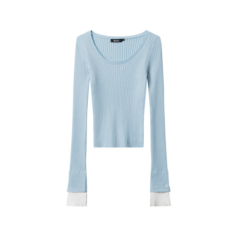 Light blue ribbed knit top with scoop neckline, fitted silhouette, and white contrast cuffs