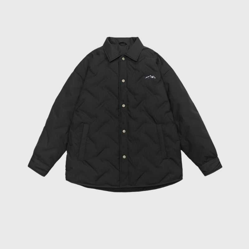 Black quilted shirt jacket with collar and small mountain logo displayed flat against light gray background