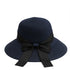 Dark navy blue straw sun hat with a black ribbon bow, featuring a wide brim for sun protection.