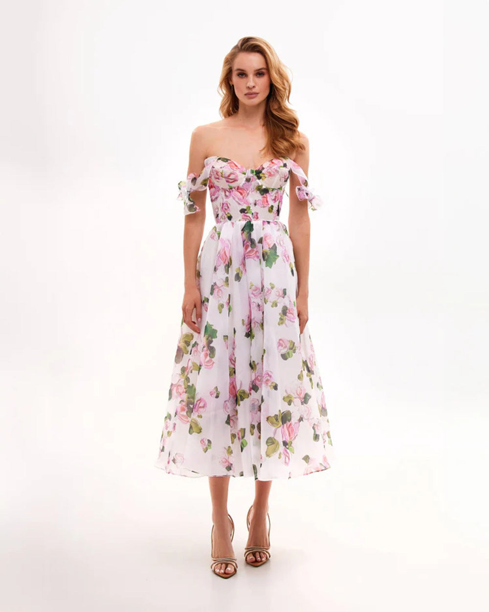 Romantic pink floral organza midi dress with off-shoulder design and delicate bow details, styled for special occasions