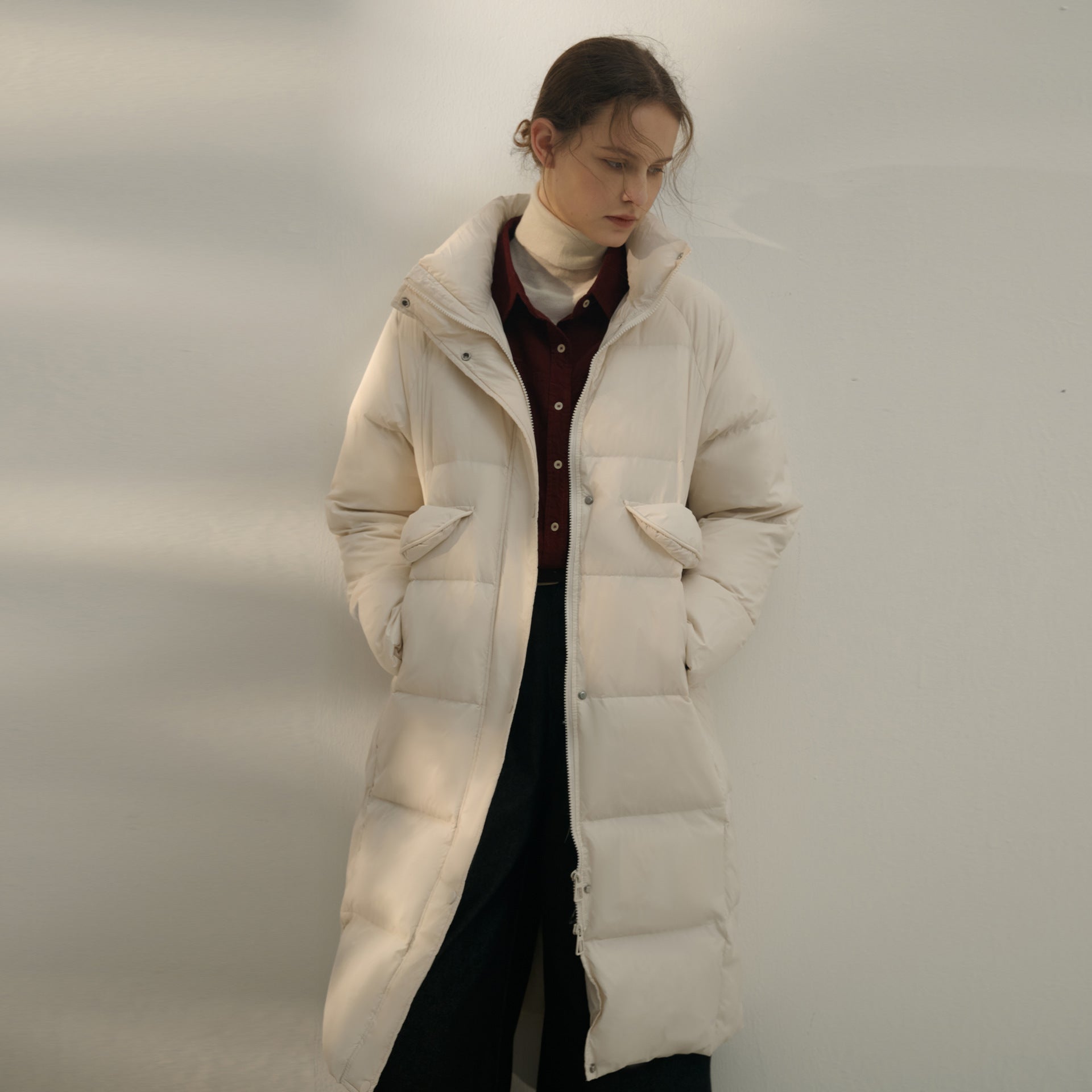 White quilted puffer coat styled with burgundy shirt and cream turtleneck, minimalist winter outfit