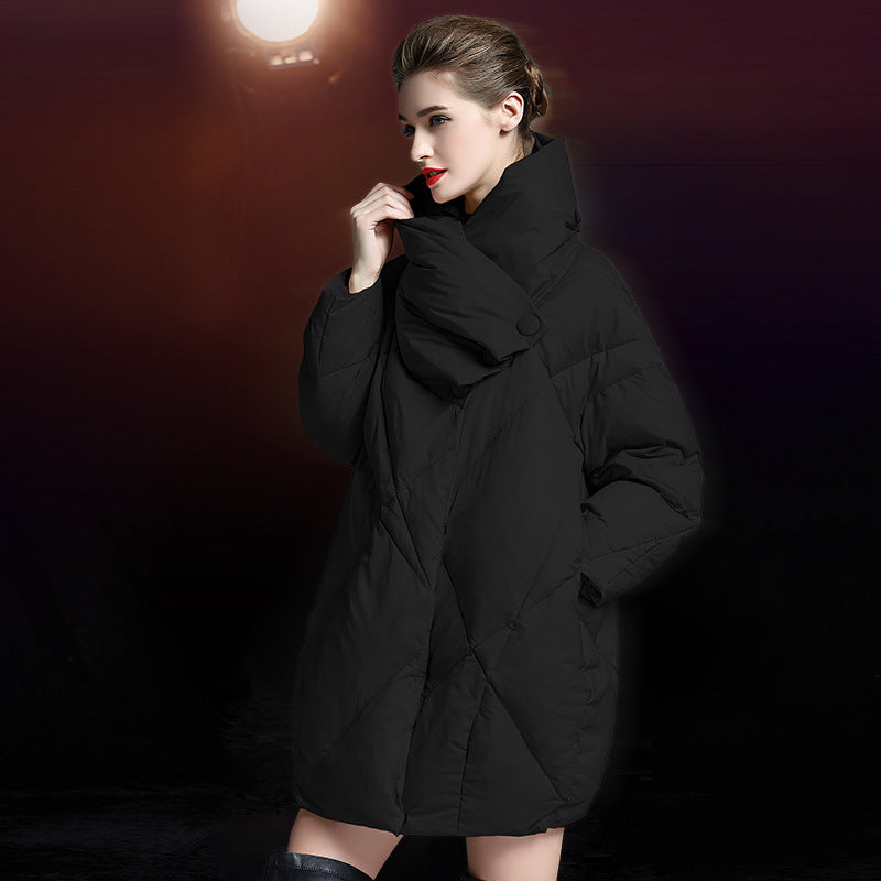 Model in black quilted puffer coat with high collar and cocoon silhouette, styled with elegant makeup and red lipstick
