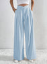 Light blue pleated wide-leg trousers with high waist and side pockets.