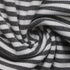 Close-up of black and white ribbed striped fabric, swirled to showcase texture and material.