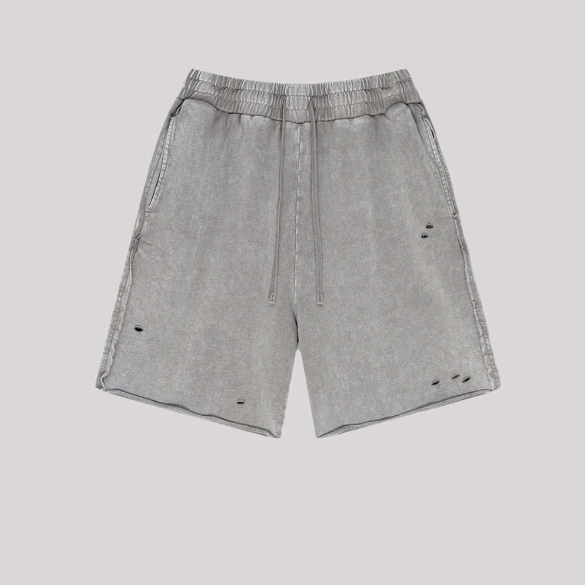 Light gray distressed sweatshorts with intentional holes and worn detail