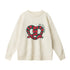 White colored sweater with red and green pretzel embroidery design