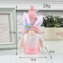 A pink Easter gnome with bunny ears, a floral hat, and a glowing body, measuring 17cm tall, placed on a decorative surface.