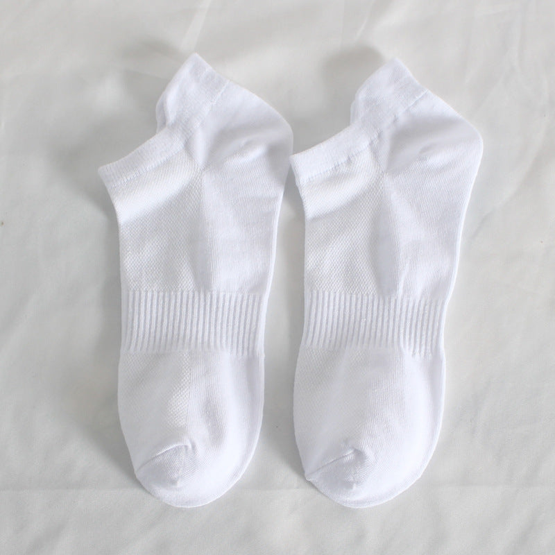 Pair of white athletic ankle socks laid flat showing cushioned sole design
