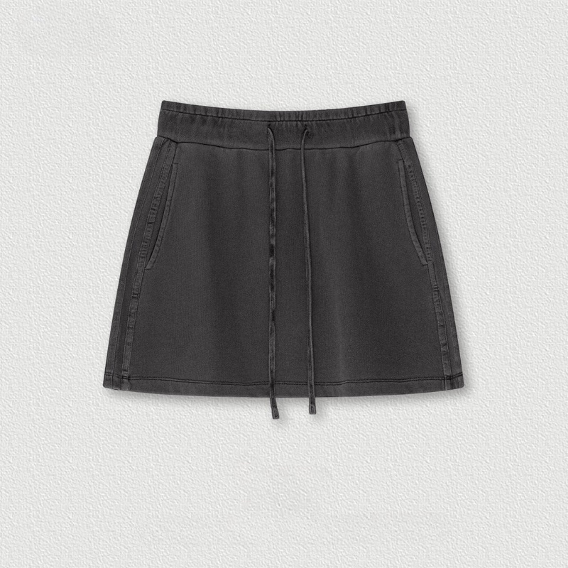 Black cotton mini skirt with drawstring waist and side seam detail displayed on white background