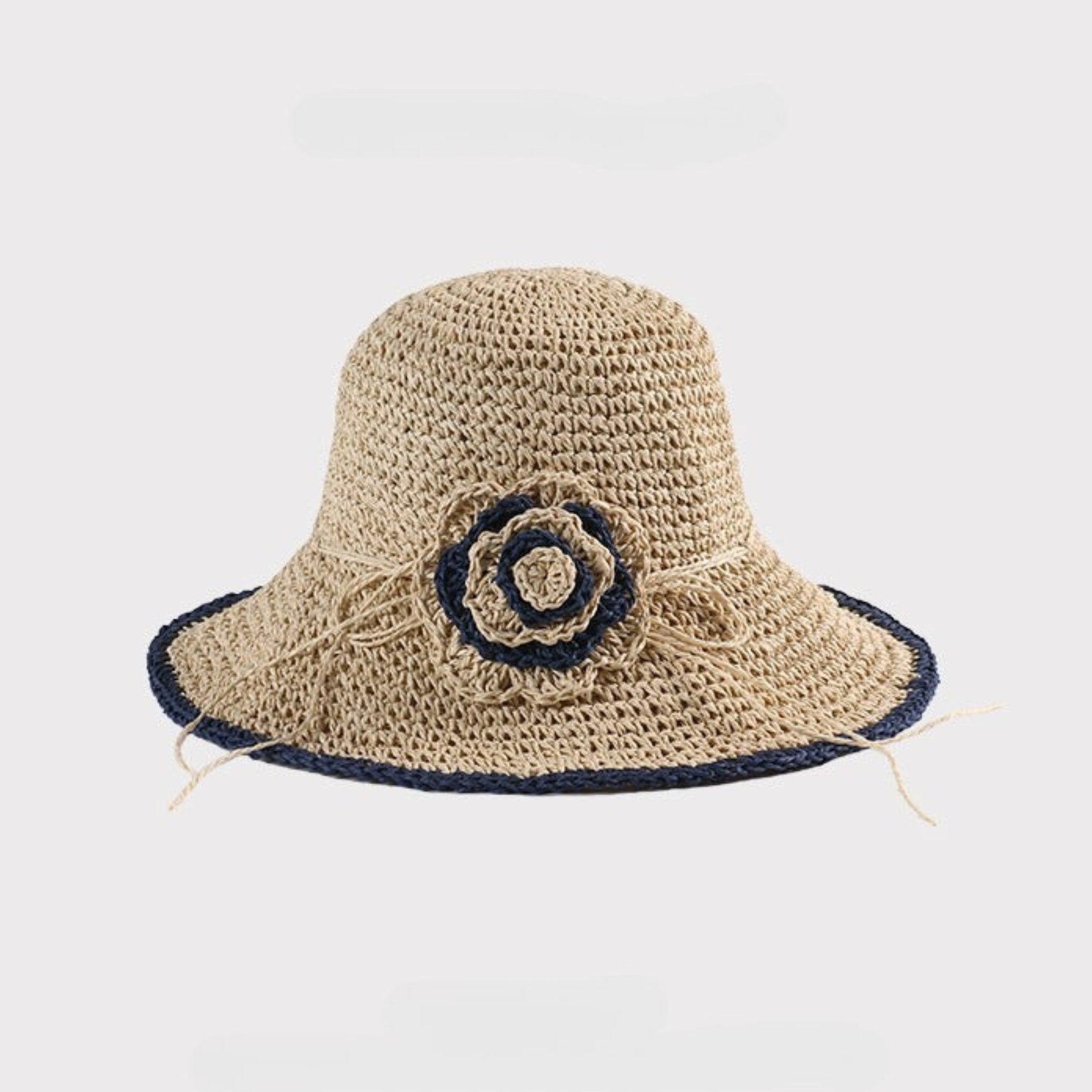  A beige woven sun hat with a navy crochet flower accent, offering a classic summer look with a flexible brim.