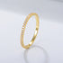 Clear zircon eternity band in 14k gold setting with classic prong design, stamped 925