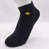 Black ankle sock featuring yellow smiley face embroidery and ribbed cuff