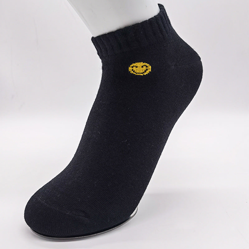 Black ankle sock featuring yellow smiley face embroidery and ribbed cuff