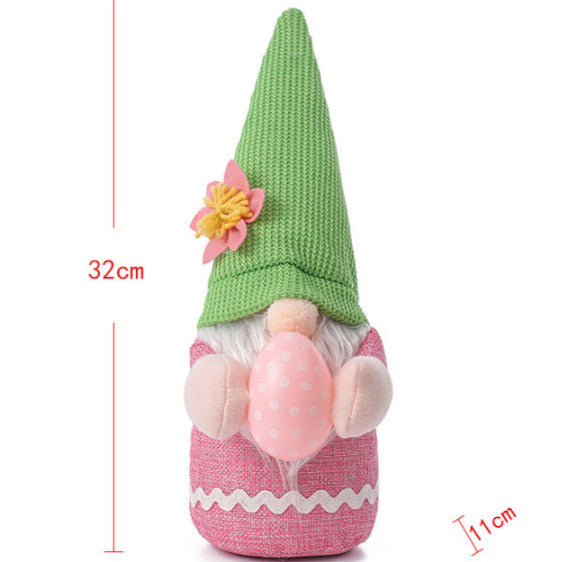 Measurement chart of a pink Easter gnome plush with a green hat, showing 32cm height and 11cm width.