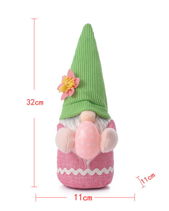 Measurement chart of a pink Easter gnome plush with a green hat, showing 32cm height and 11cm width.