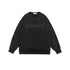 Black oversized sweatshirt with ribbed cuffs and tonal embossed "Noproblem" text, offering a sleek monochrome look