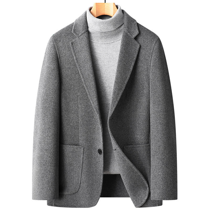 Light gray wool blazer with notched lapels and single button closure, styled with a light gray turtleneck sweater on wooden hanger