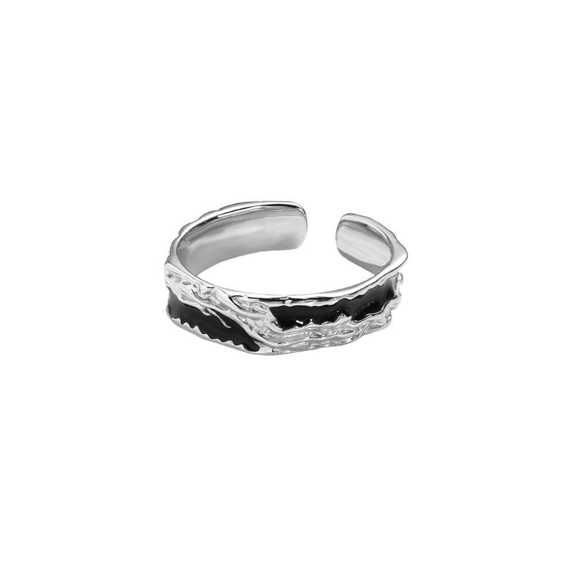 A silver open-ended ring with a black enamel wave design and a textured, rugged finish